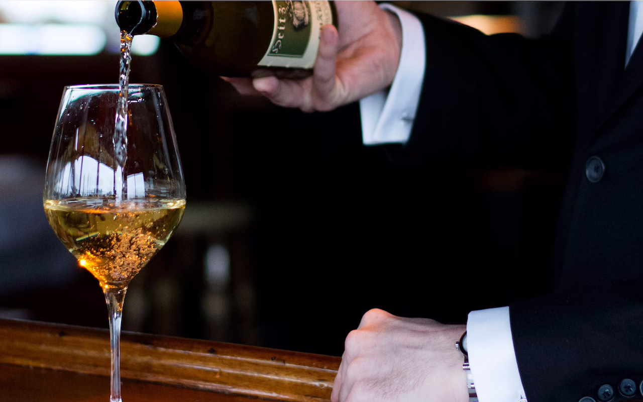 man pouring wine