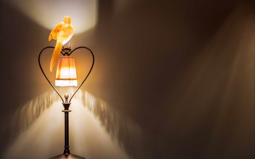 Glass birds adorn the lighting fixtures at L'oscar