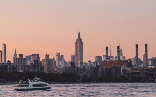 A view of the Empire State Building across the East River from Domino Park in the Williamsburg neighborhood of Brooklyn, NY.