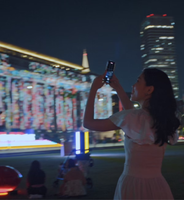 Woman taking night shots of Singapore