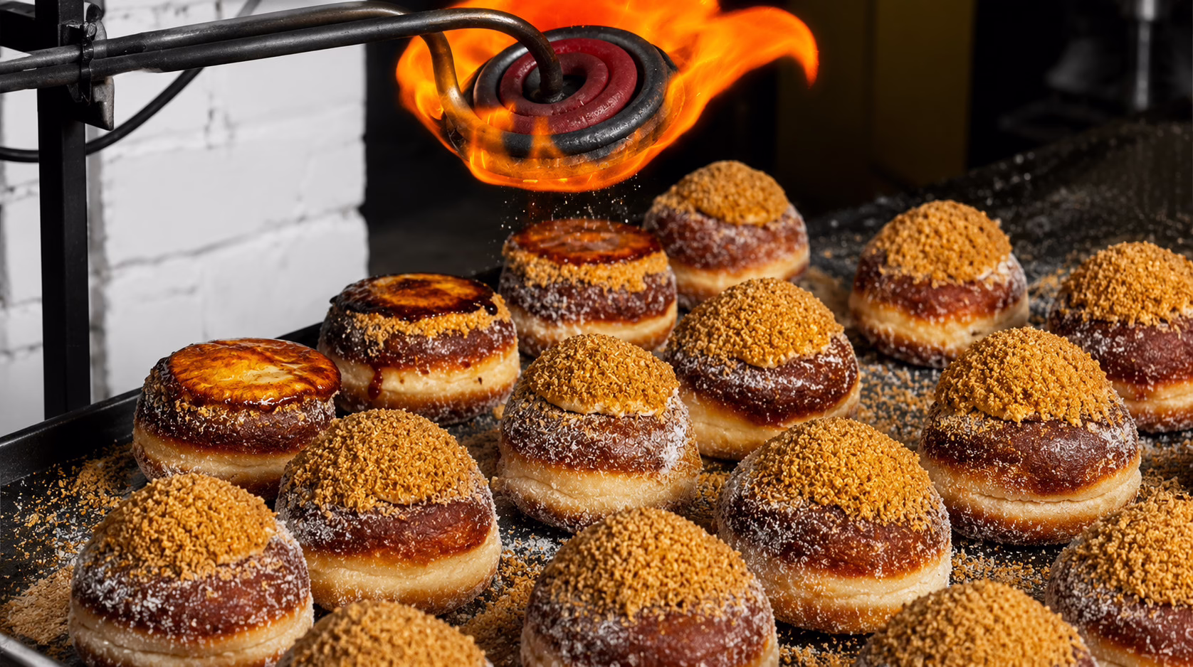 Bread Ahead staff torch crème brûlée doughnuts at the bakery’s Hot Doughnut Theatre in Bangkok, caramelising the sugar topping to order.