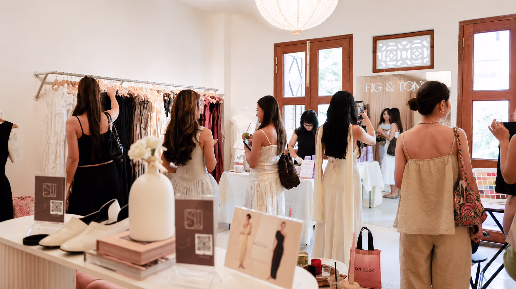 Guests exploring the curated fashion selection at With Love on Neil Road