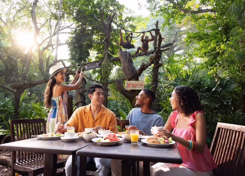 Guests enjoying Breakfast in the Wild surrounded by rainforest greenery at Singapore Zoo