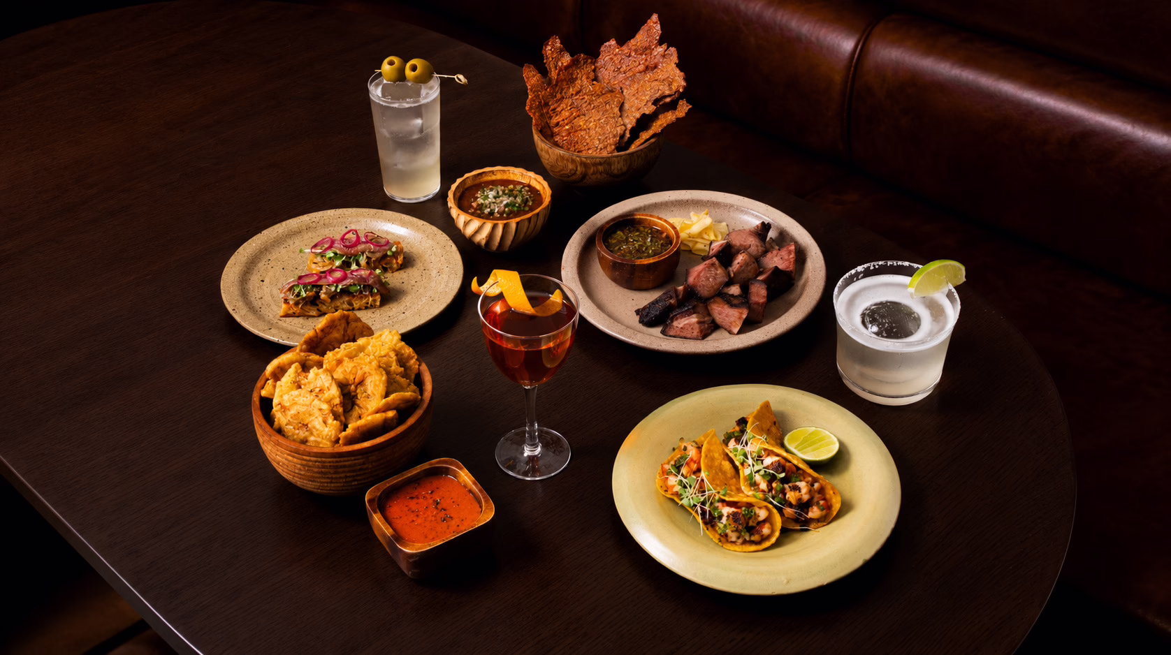 Latin American-inspired food and cocktails at Toma y Toma cocktail bar in Bangkok, including small plates and signature drinks.
