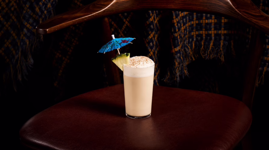Toma y Toma’s Horchata Ramos cocktail in Bangkok, a tropical Ramos Fizz variation with pineapple garnish.