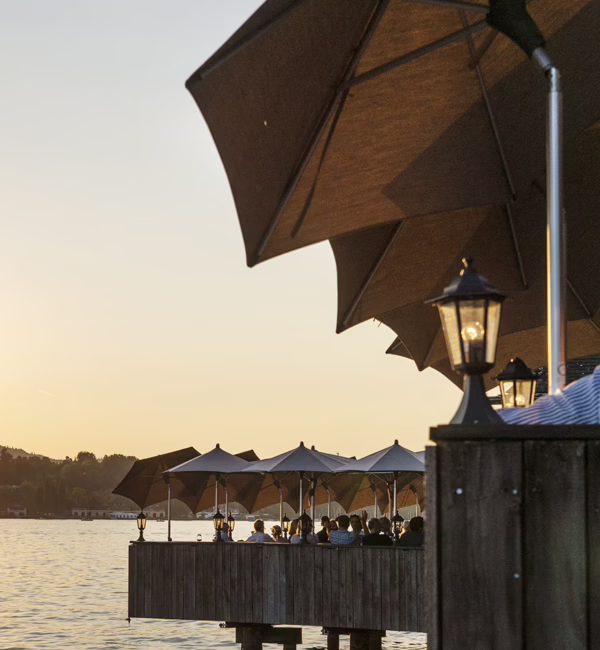 Sunset view from Fischerstube's lakeside terrace on Lake Zurich