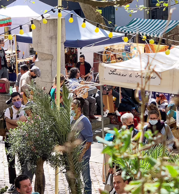 Stalls selling handcrafted jewellery, ceramics, textiles and souvenirs at Rosenhof Market in Zurich’s Old Town.