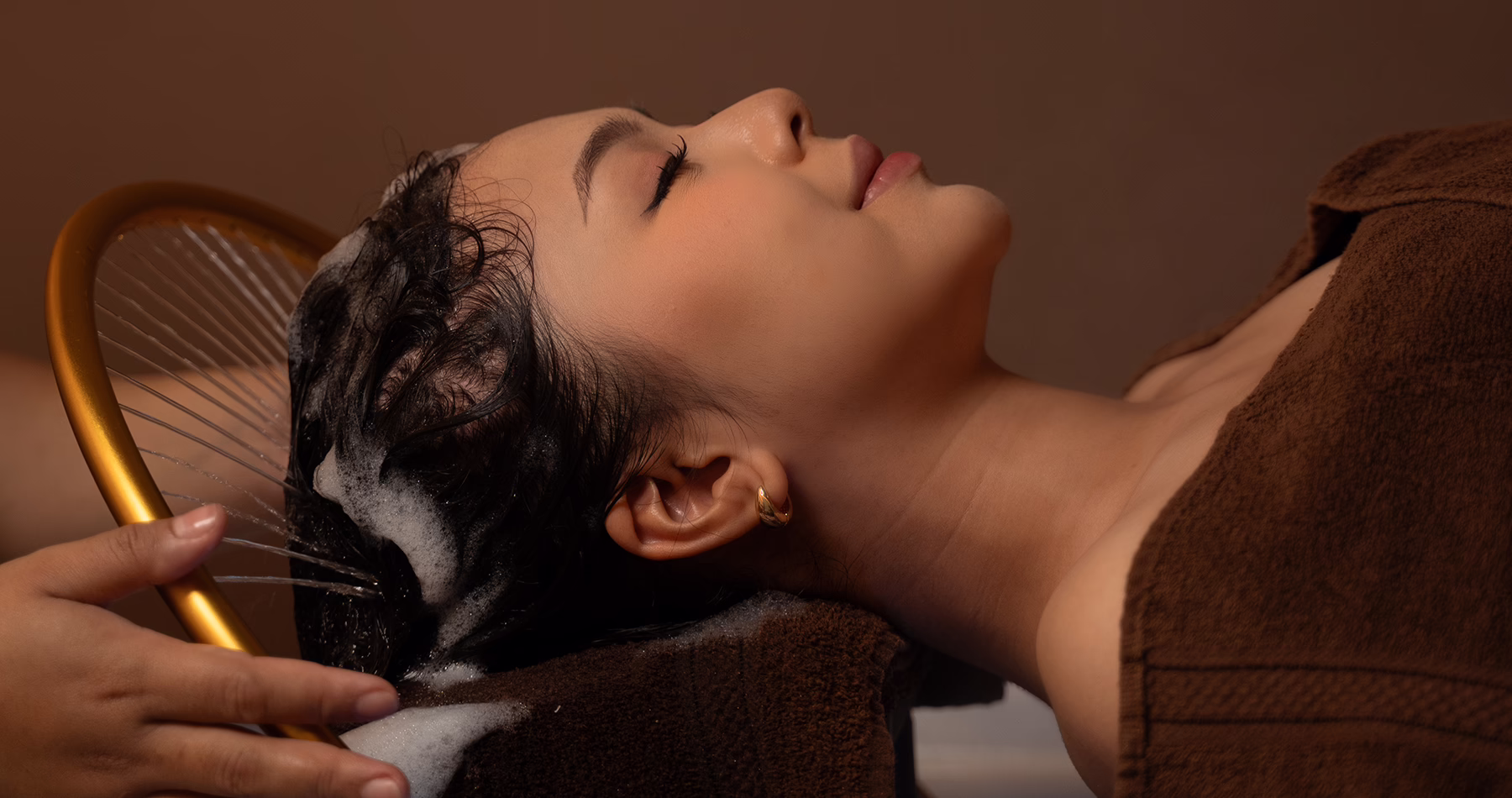 A client receives a Waterfall Head Spa treatment at May May Salon in Jakarta