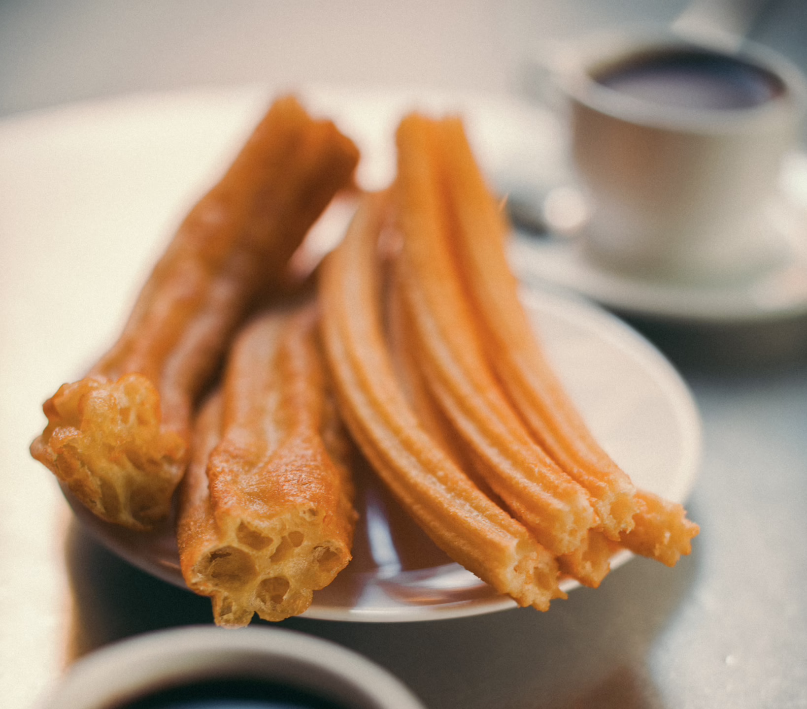 Churros con chocolate served with thick hot chocolate in Madrid