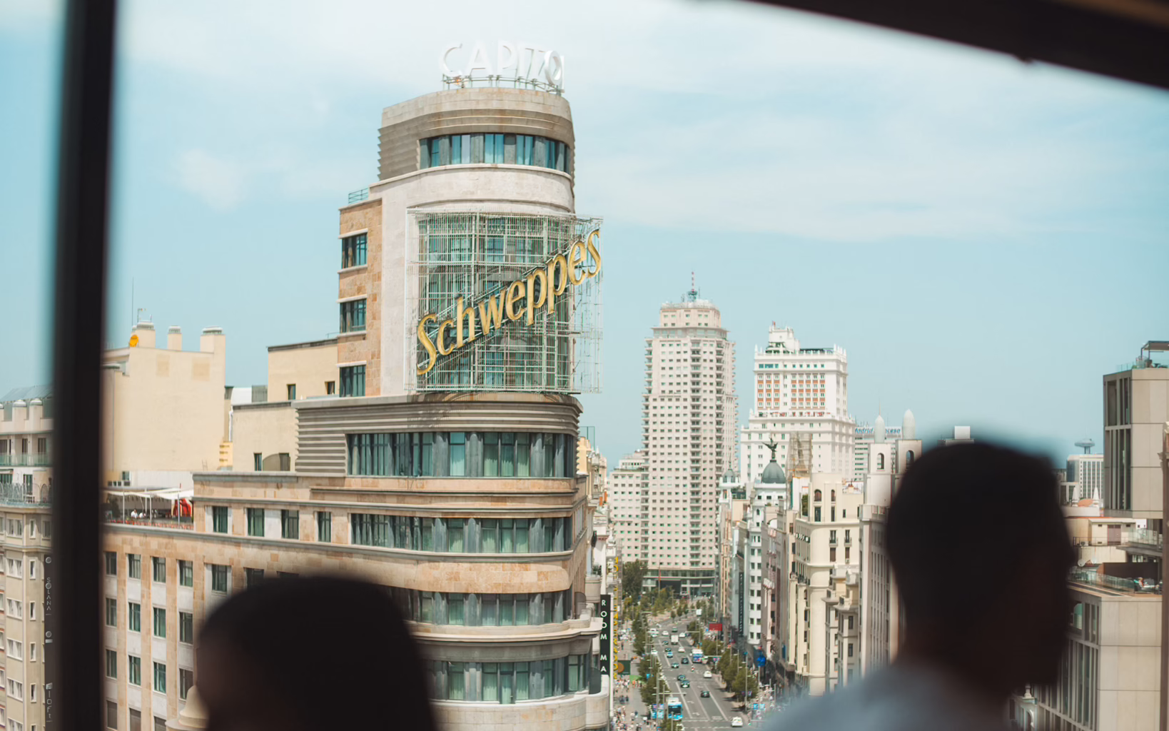Gran Via in Madrid with the illuminated Schweppes sign on the Capitol Building