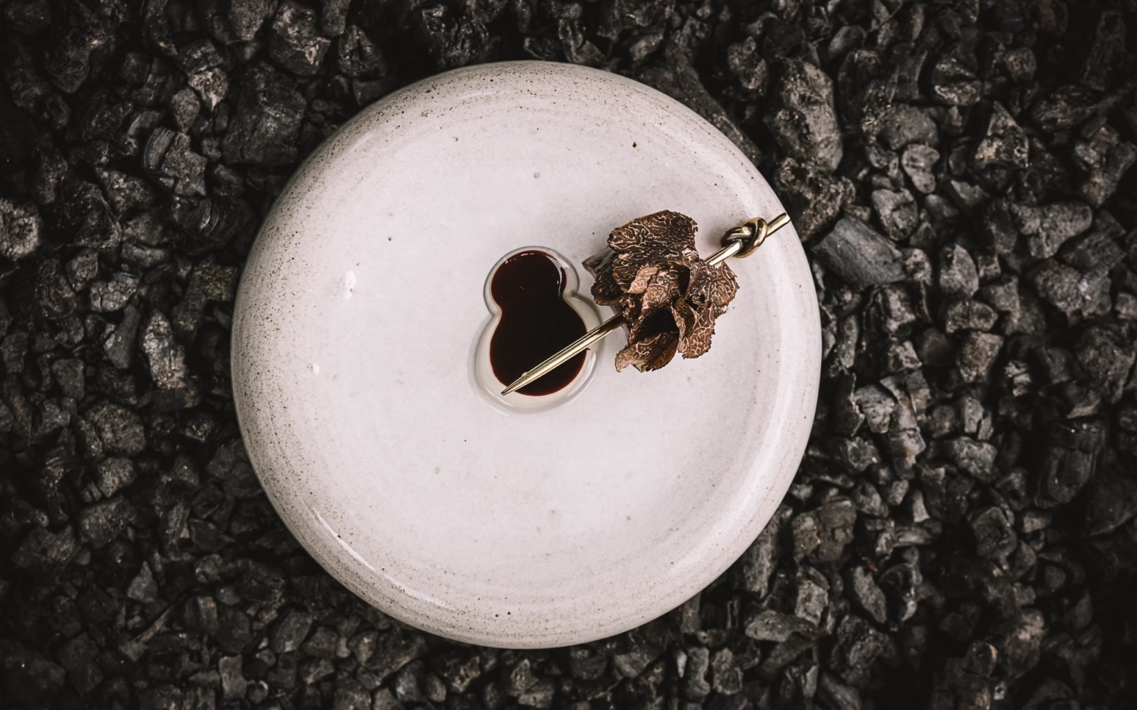 Grilled fallow deer with truffles, burnt bone marrow, moss and a forest berry sauce