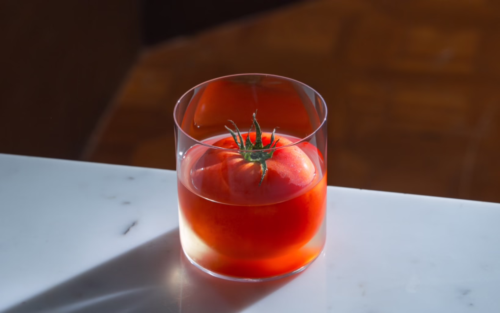 Bangkok Brunch reimagines pad krapow as a clarified Bloody Mary, pairing savoury, smoky notes with a frozen tomato garnish
