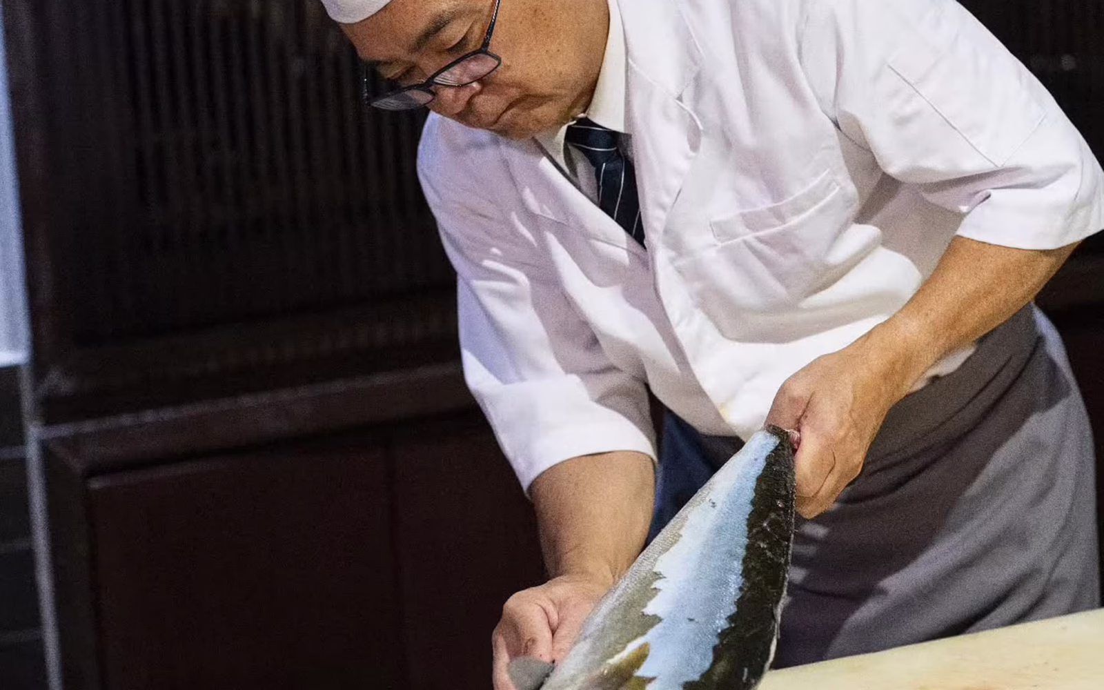 Chef slicing fresh fish at Hanare Kuala Lumpur