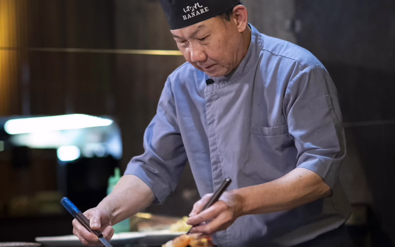 Chef preparing a dish at the teppan counter at Hanare Kuala Lumpur