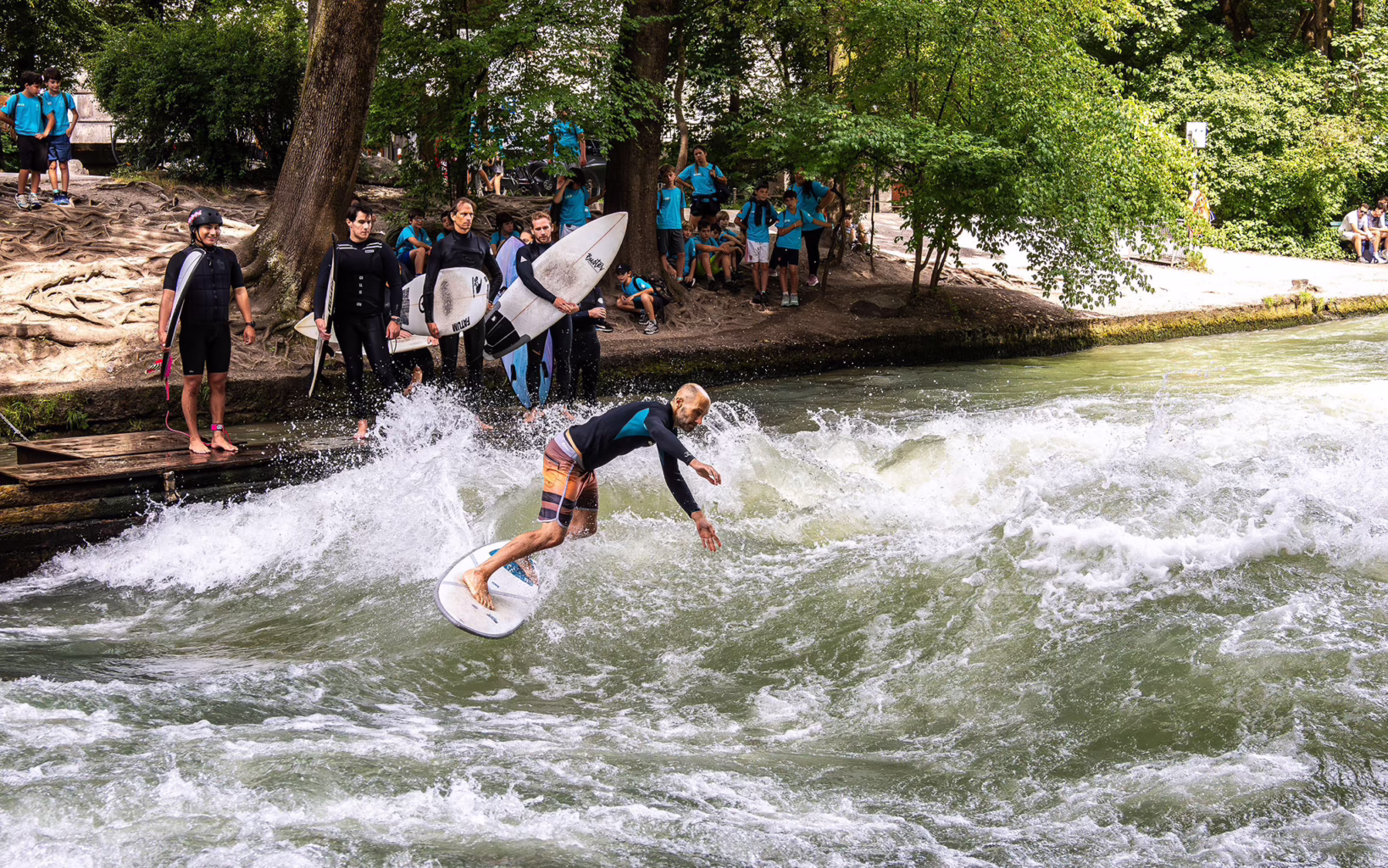 Surfer riding the Eisbachwelle in Munich’s Englischer Garten