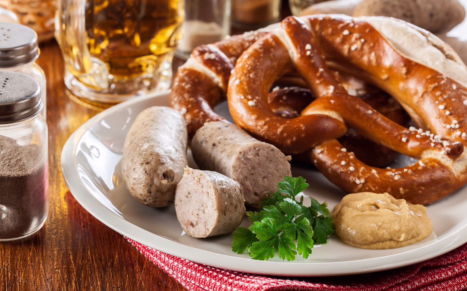 Traditional Bavarian breakfast with white sausage, pretzel and beer in Munich