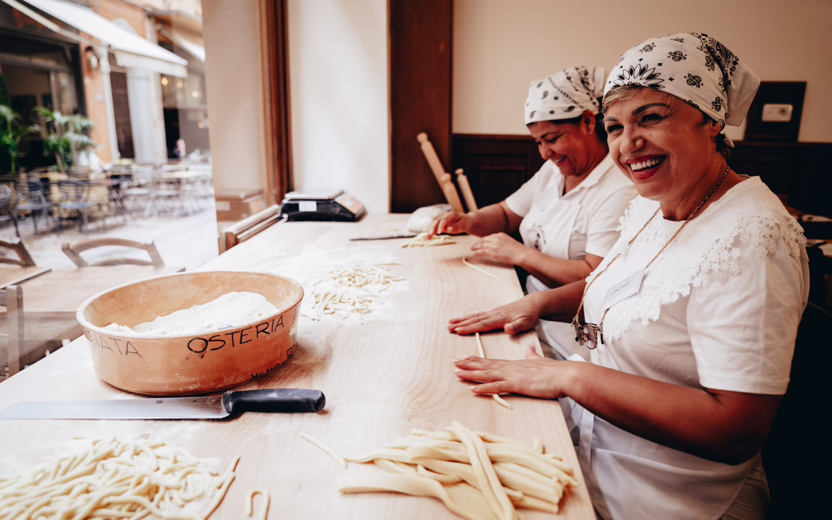 Women hand-rolling fresh pasta at Osteria da Fortunata in Rome