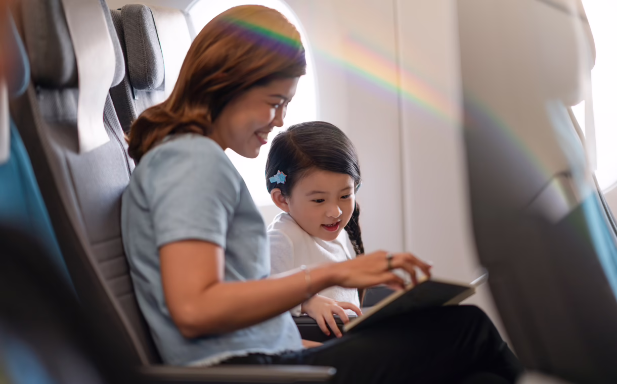 Mother and child with Singapore Airlines children’s amenities onboard a flight