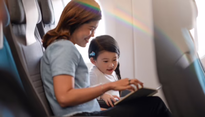 Mother and child with Singapore Airlines children’s amenities onboard a flight