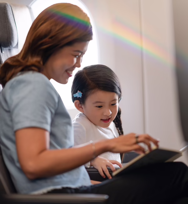 Mother and child with Singapore Airlines children’s amenities onboard a flight