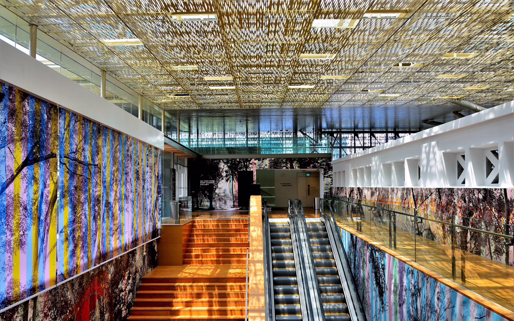 Sunlit staircase and escalator inside National Gallery Singapore