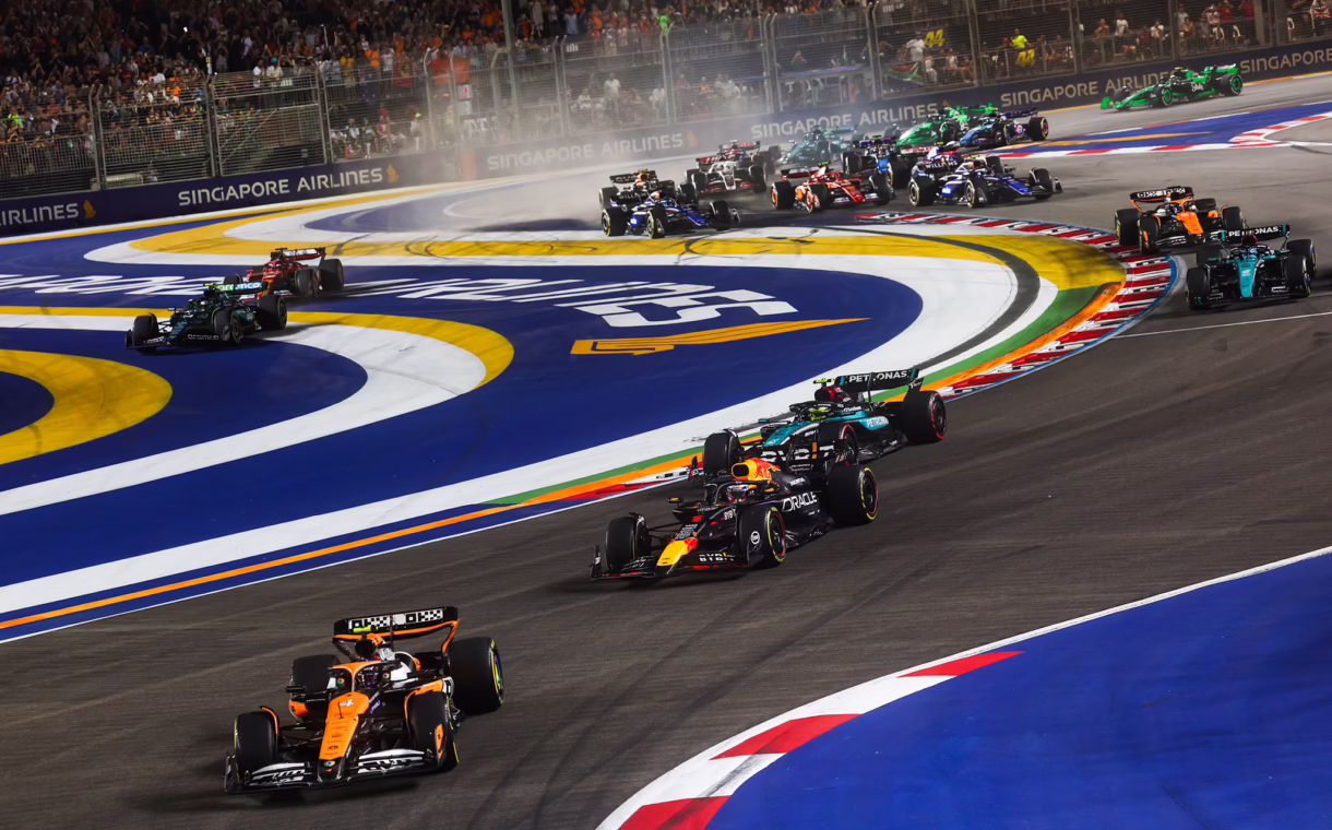 Formula 1 cars racing on the Marina Bay Street Circuit during the Singapore Grand Prix