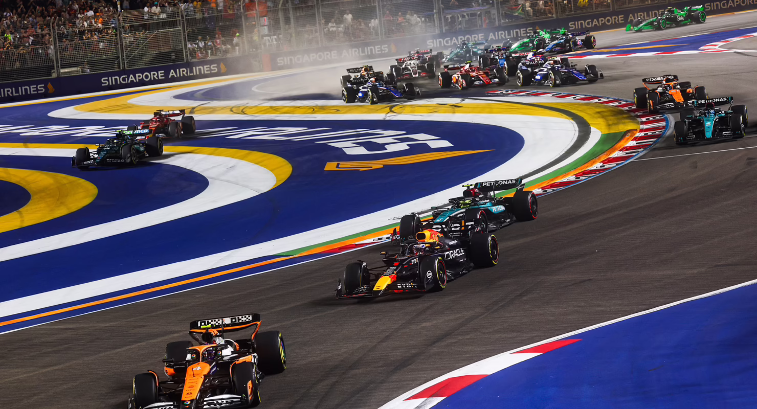 Formula 1 cars racing on the Marina Bay Street Circuit during the Singapore Grand Prix