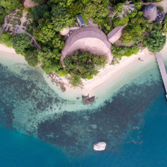 Tropical coastline, clear waters and lush greenery on Cempedak Island, Indonesia.