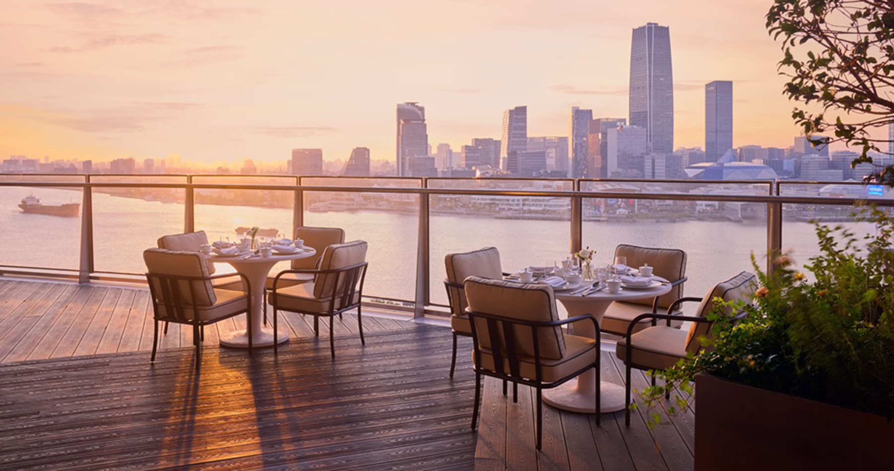 Outdoor terrace at Fu Cheng overlooking Shanghai and the Huangpu River at sunset.