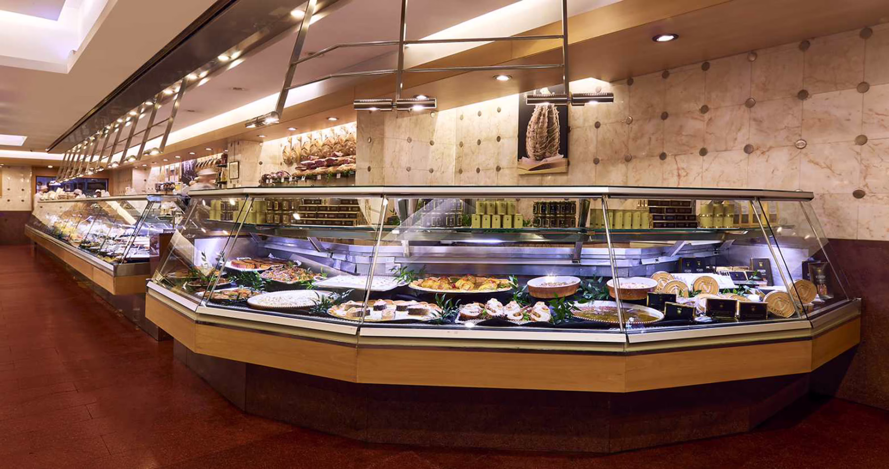 Gourmet food counters displaying prepared dishes and Italian specialities inside Peck in Milan.