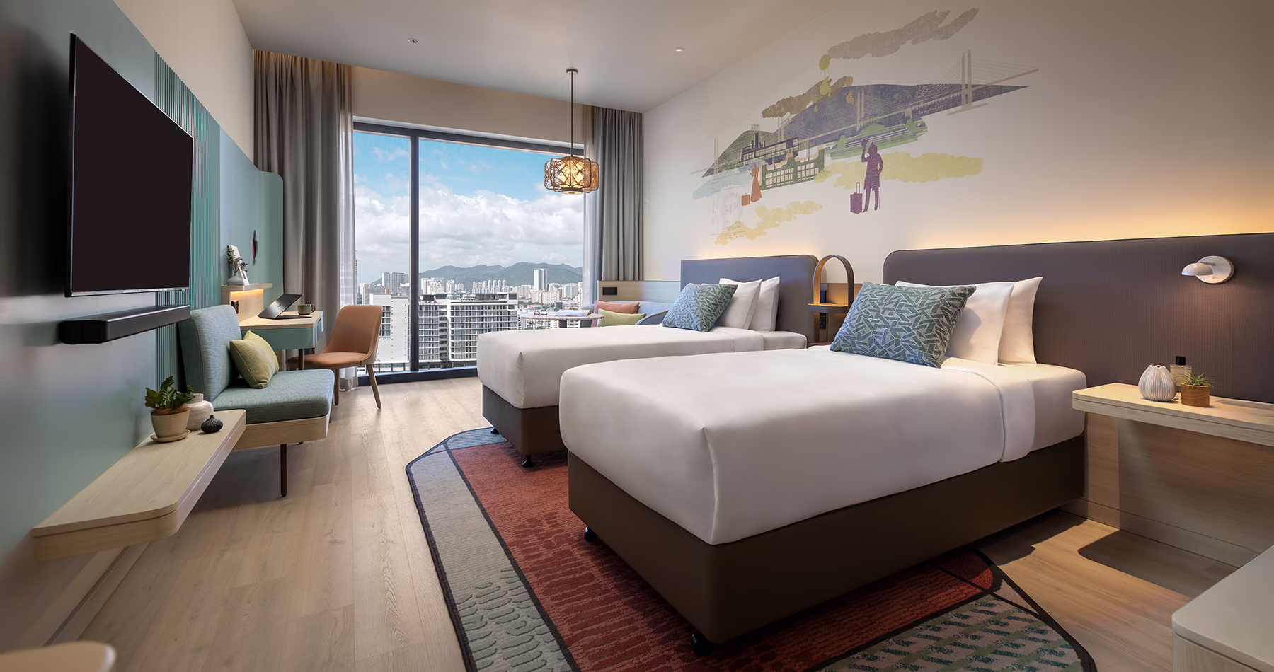 Premier Twin room at Capri by Fraser, Penang, featuring two single beds, colourful wall art, contemporary furnishings and floor-to-ceiling windows overlooking the city.
