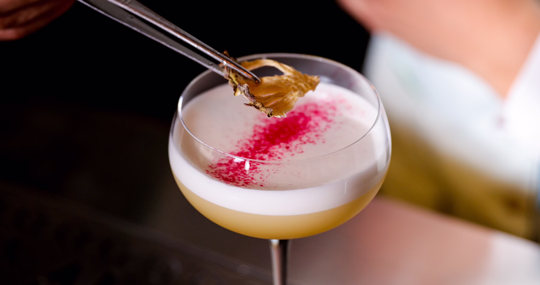 Bartender adding the finishing garnish to a cocktail at Alma Luna Shanghai.