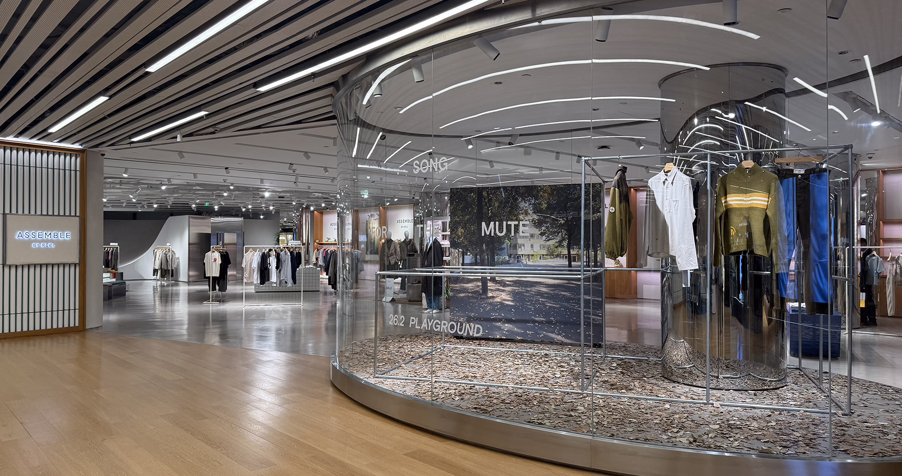 Interior of Reel Shanghai, featuring contemporary fashion boutiques, curved glass displays and minimalist retail interiors.