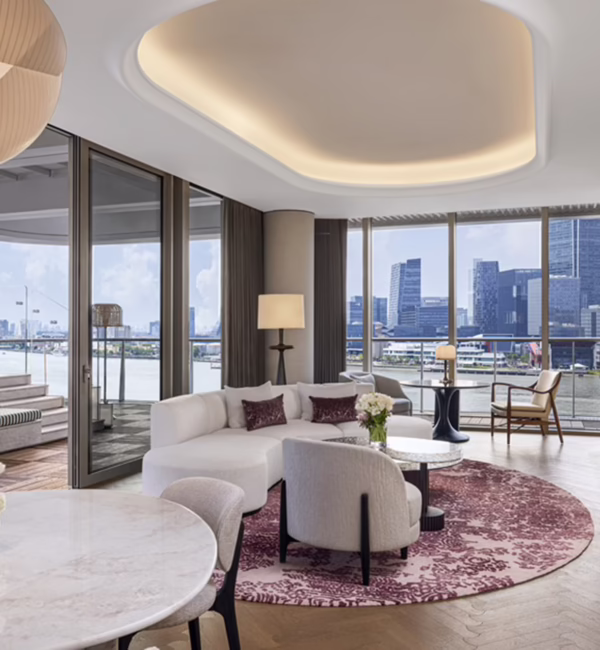Suite at Waldorf Astoria Shanghai Qiantan, featuring contemporary interiors and panoramic views of the Huangpu River.
